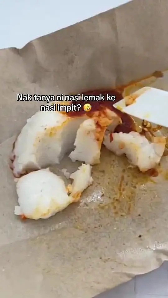 M'sian woman struggling to break the nasi lemak rice. 