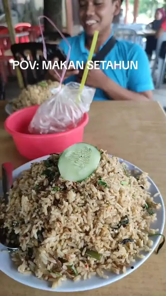 A M'sian shows the portion of fried rice that he received after ordering at a stall. 