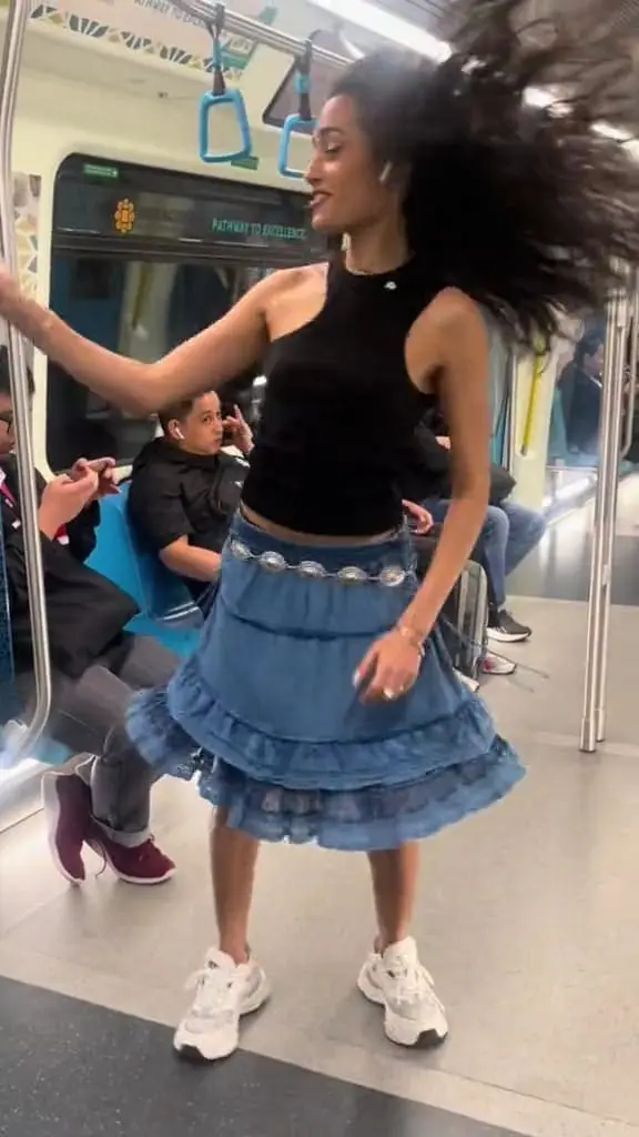 A man sneakily looking at Tube Girl filming TikTok trend.