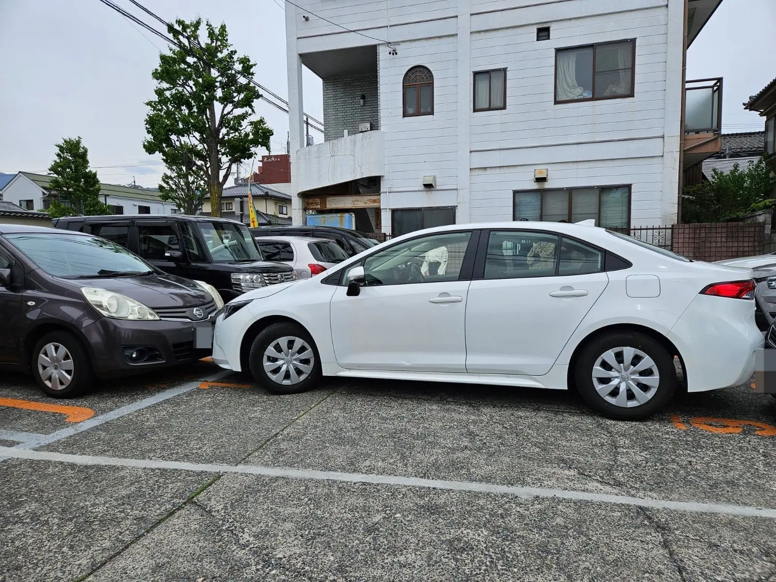 car double parked by M'sian in Japan