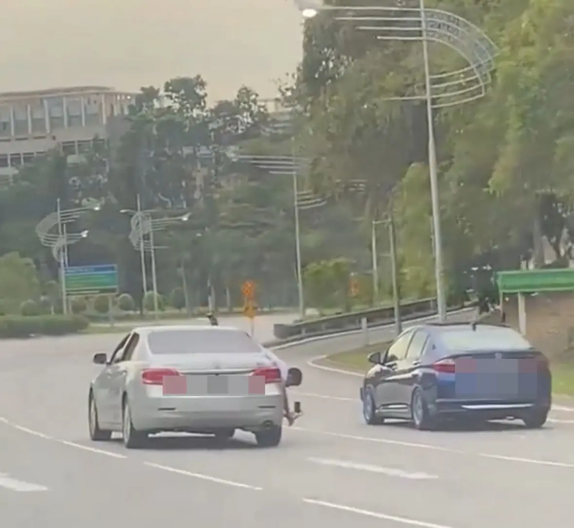 M’sian man leans out of moving car to film Honda City