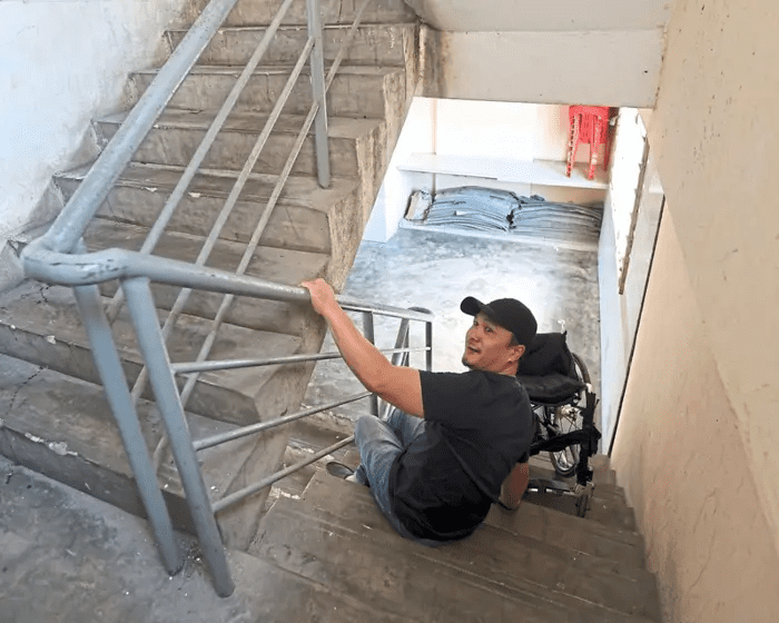 Wheelchair-bound man using the stairs