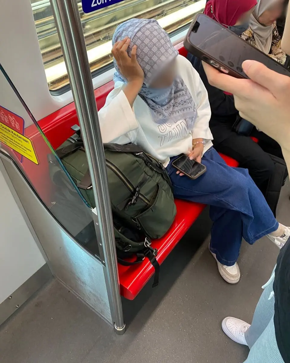 Woman 'books' priority seat with bags