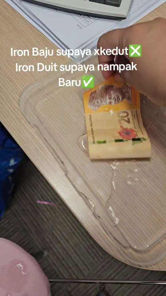 woman dipping money inside water