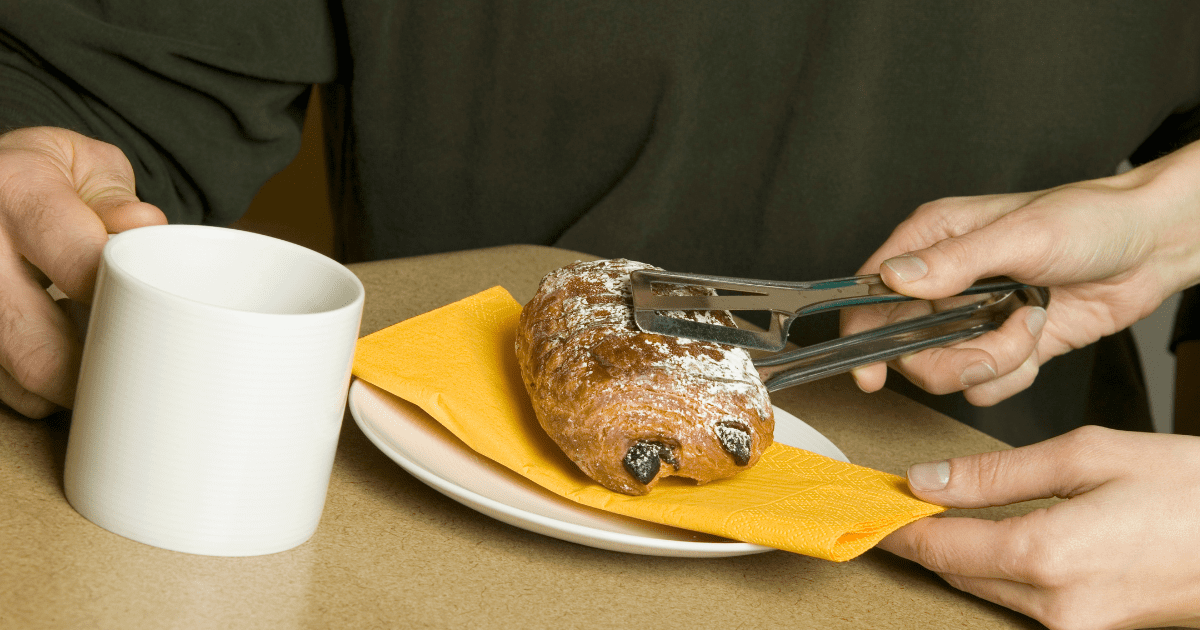 woman is putting chocolate danish on a man's plate