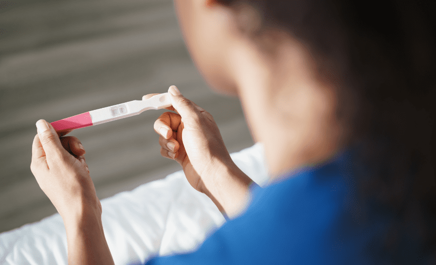 woman looking at her pregnancy result
