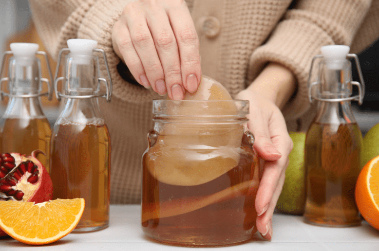 woman making kombucha
