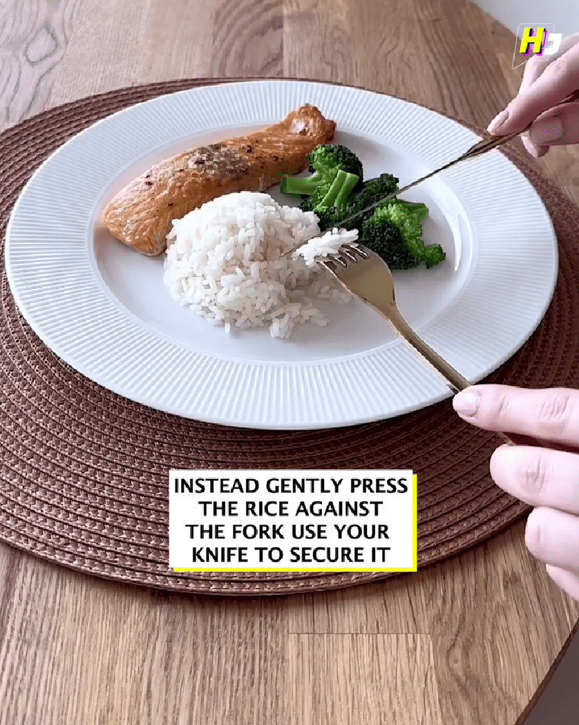 woman scoopinhg rice with fork