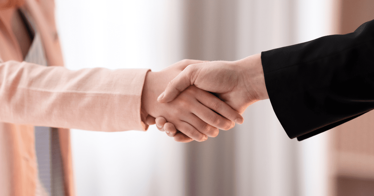 woman shaking hand with her boss