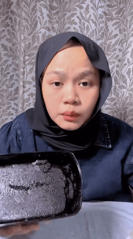 woman showing mouldy cake she bought of rm39