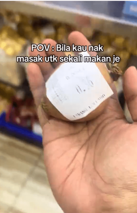 woman showing one piece of onion she bought