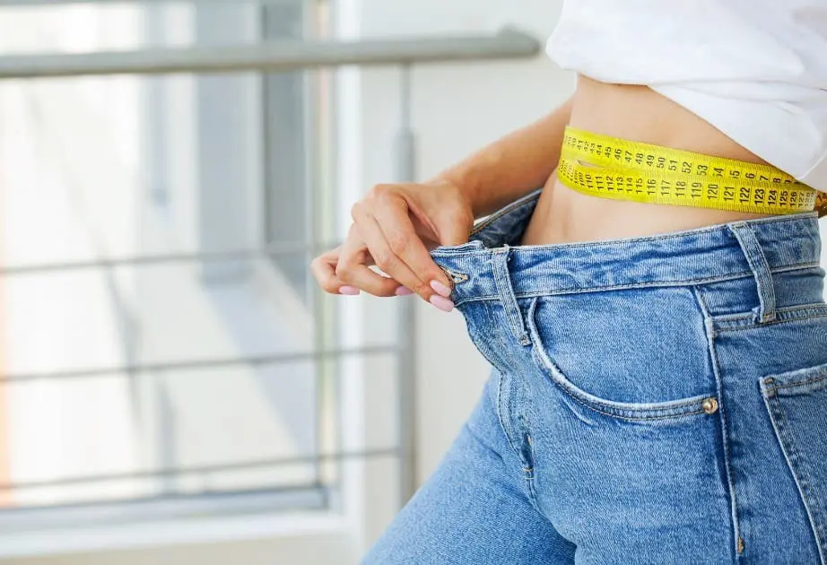 woman showing result of losing weight