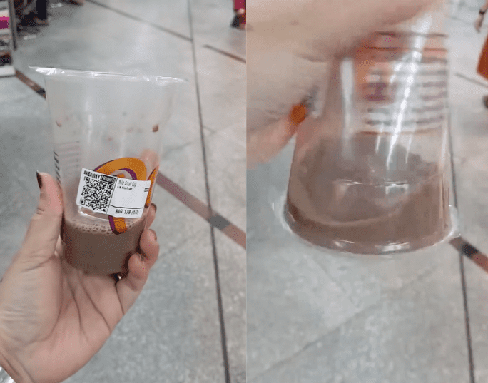 Woman shows quarter-full drink