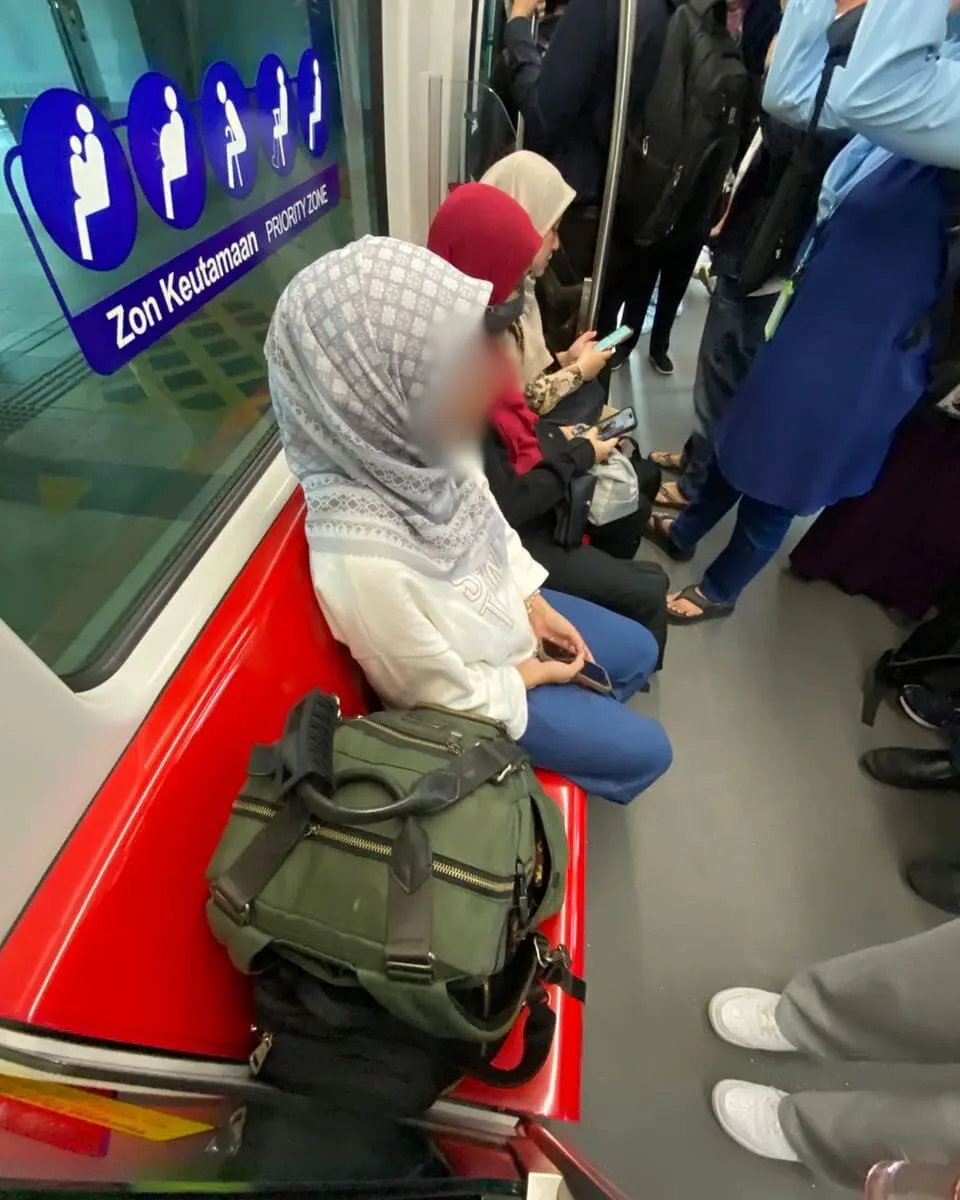 Woman sits along priority seats
