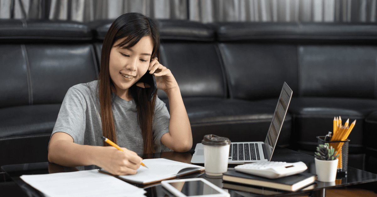 woman writing while talking