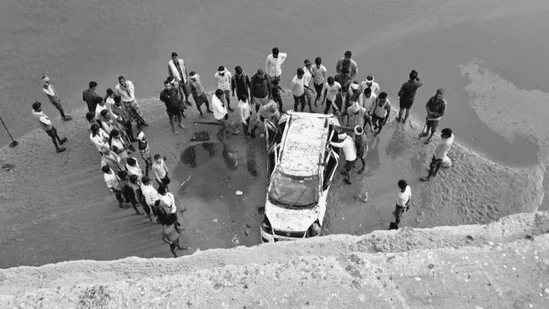 Wreckage of car that fell from unfinished bridge in India