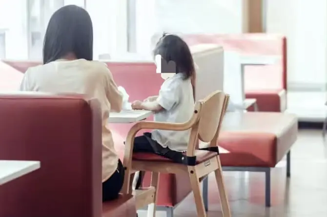 Young girl having a meal with her mum
