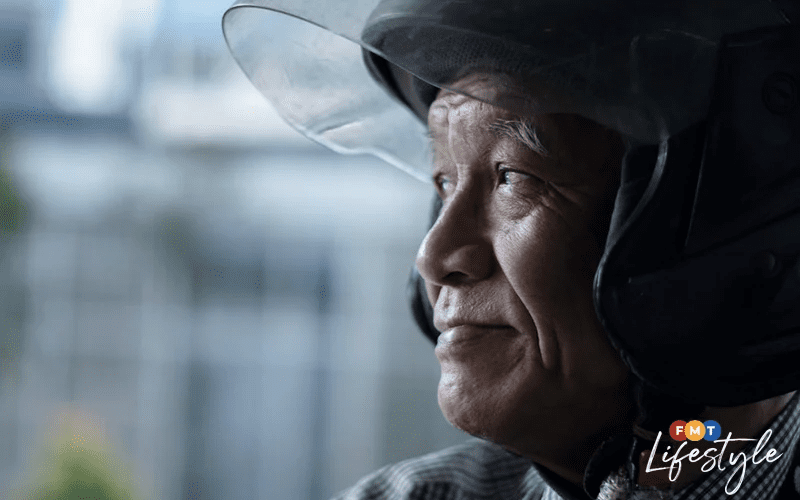 70yo Grab rider Zakaria Abdul Wahab looking elsewhere