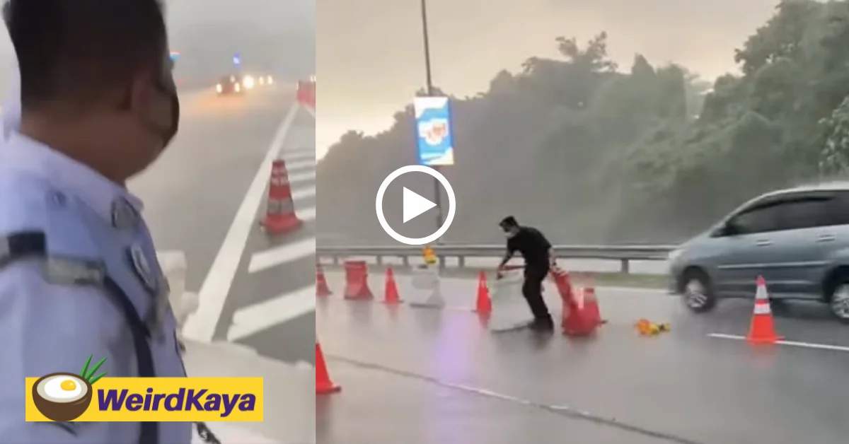 [video] brave policeman praised for removing traffic barriers amidst a heavy storm | weirdkaya