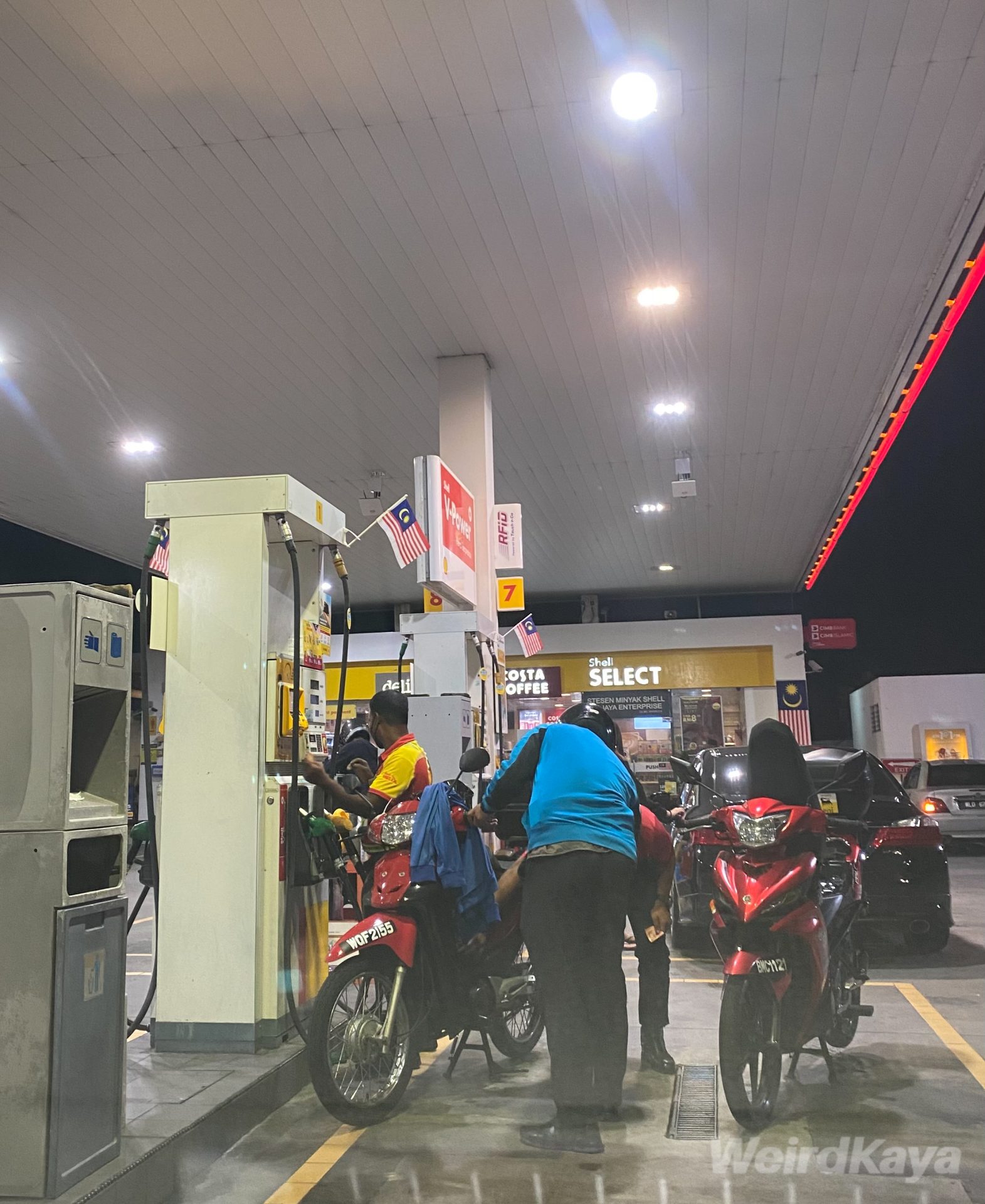 wk petrol station motorcycle pumping petrol