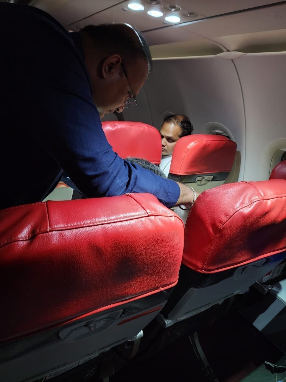 Dr. Sathia Prakash Nadarajan is checking the condition of a woman he treated on the flight.Â