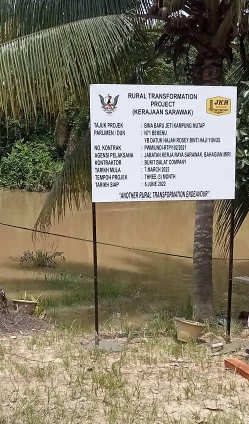 Signboard held in front of the wooden jetty