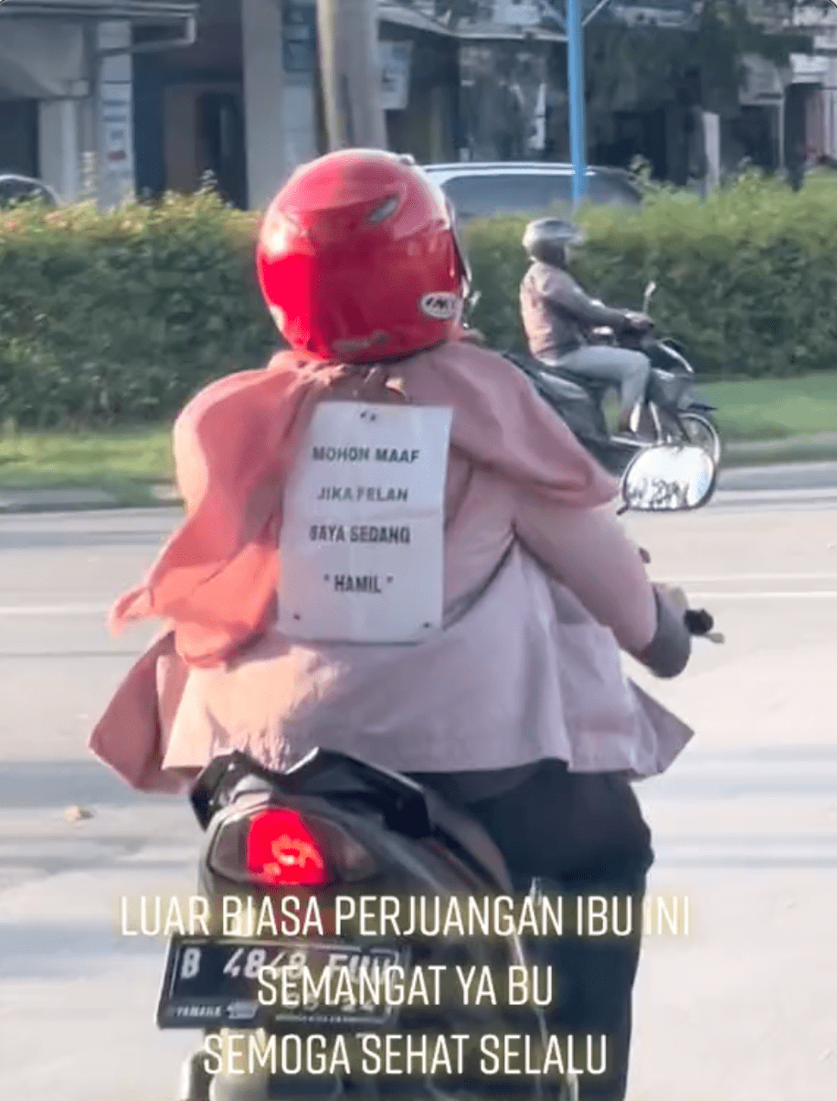 'sorry, i drive slow as i'm pregnant' m'sian cyclist puts up sign on her back while riding a motorcycle