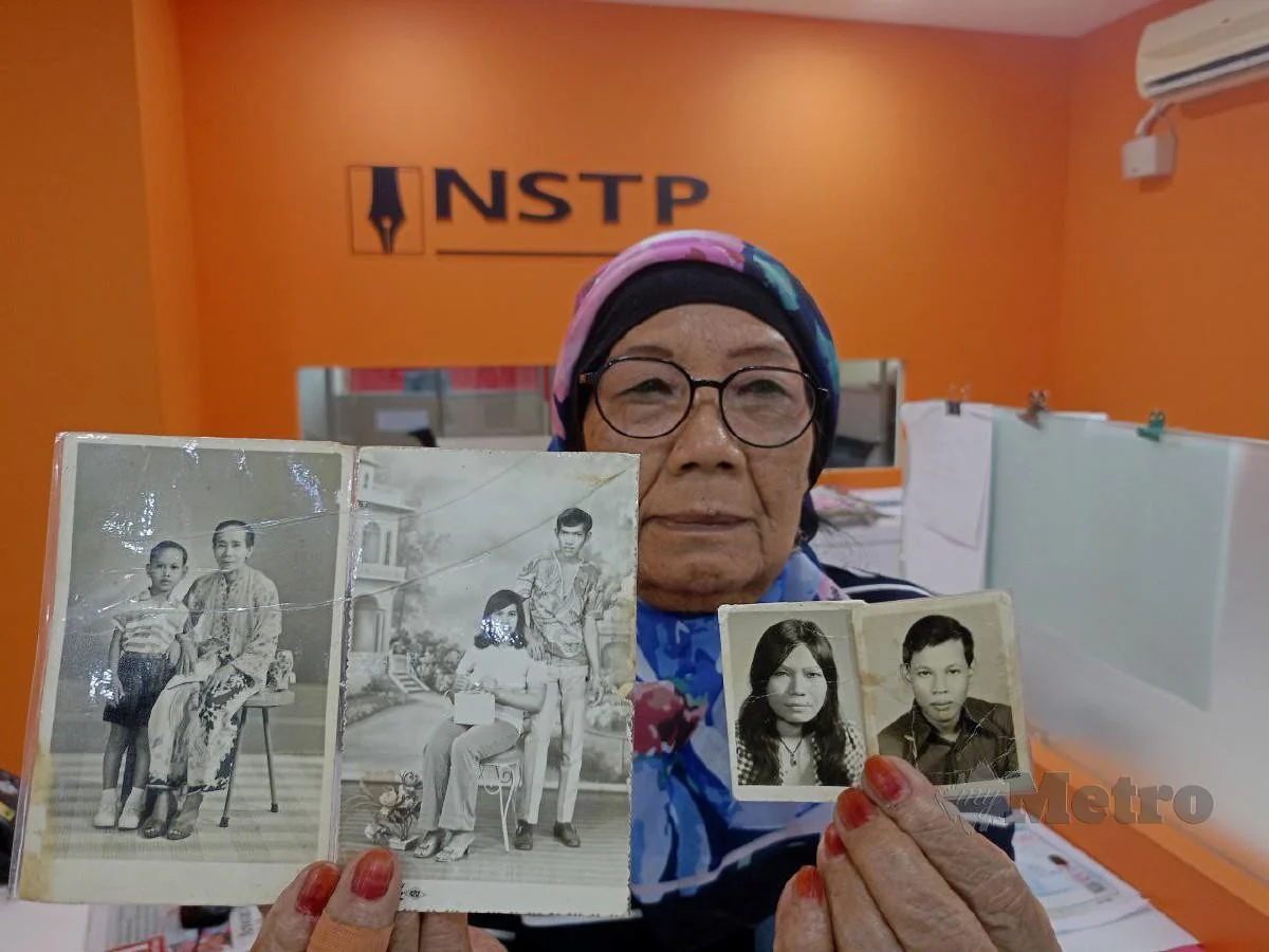 a malaysian mother showing photograph of her children