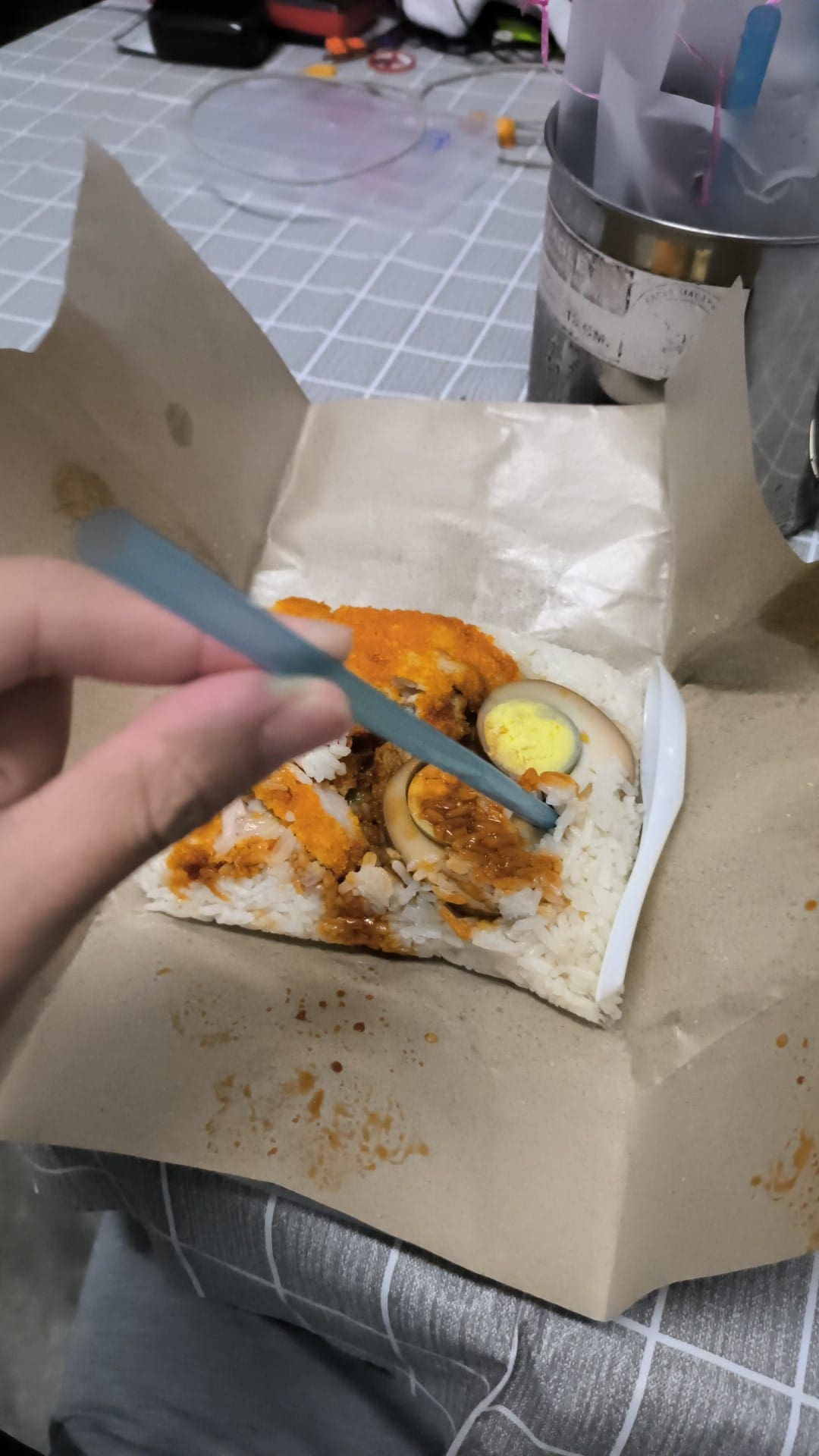 a man using straw as a spoon to eat 