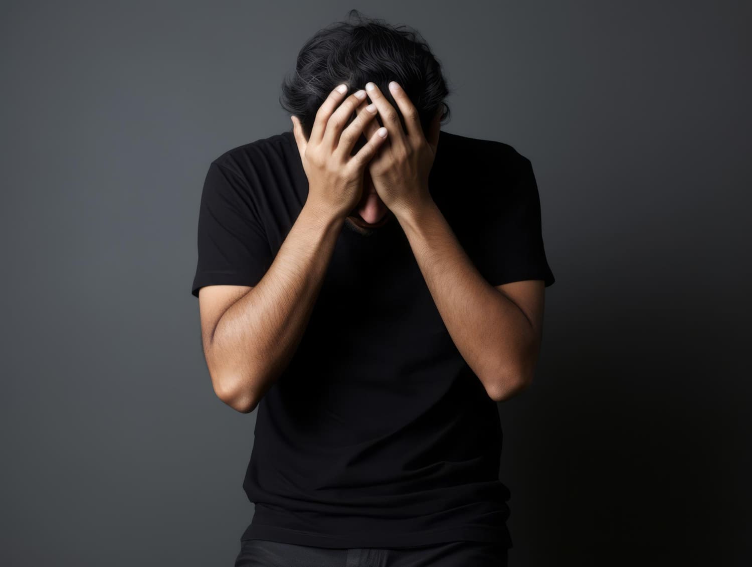 Man puts his hands on his face covering