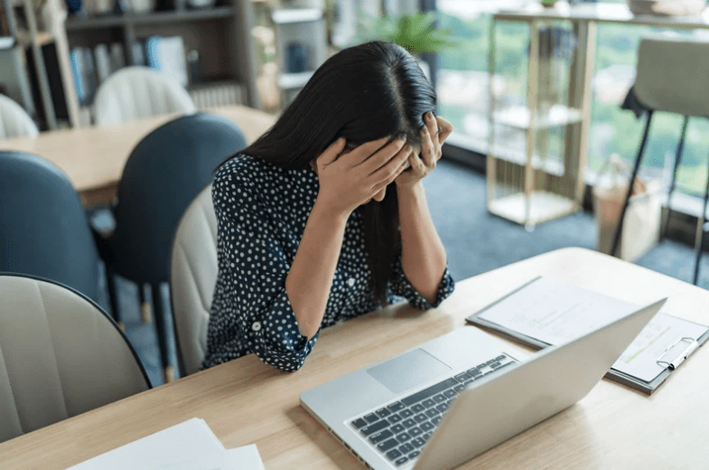 Asian woman stressed at work