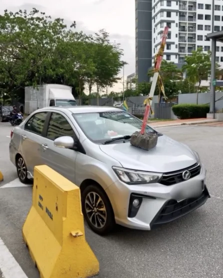 Bezza Parked At Road Corner Ends Up Having Metal Barrier Pole Placed On Its Bonnet