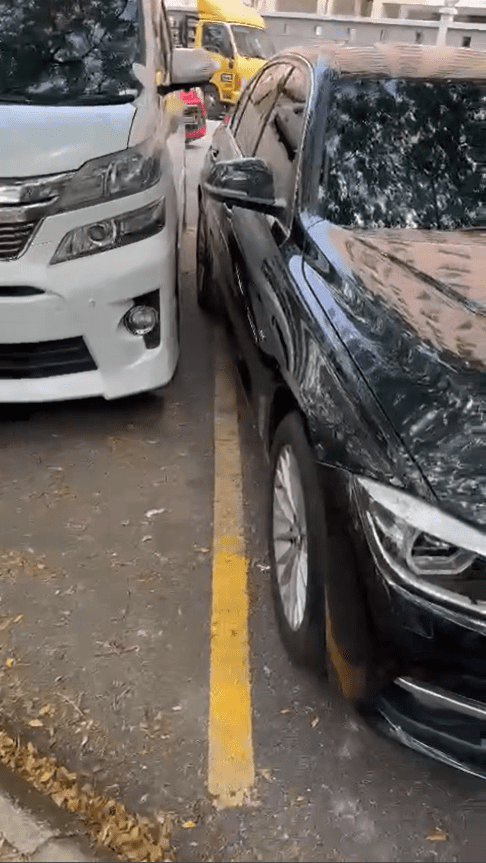 BMW parked beyond space lines