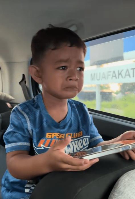 Boy crying when escort police stop them
