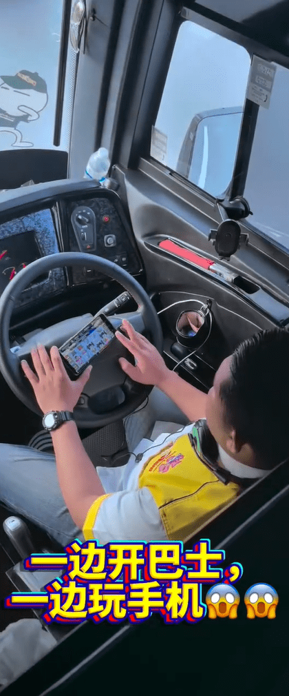 Bus driver playing game while on the road