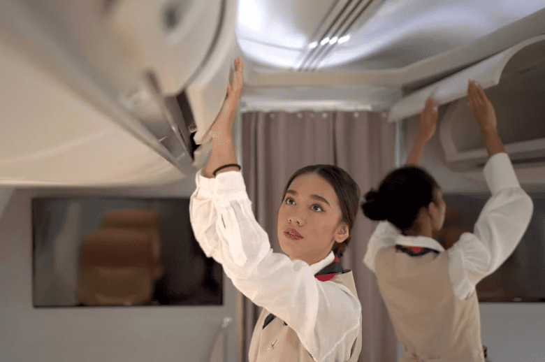 Cabin crew closing overhead compartment