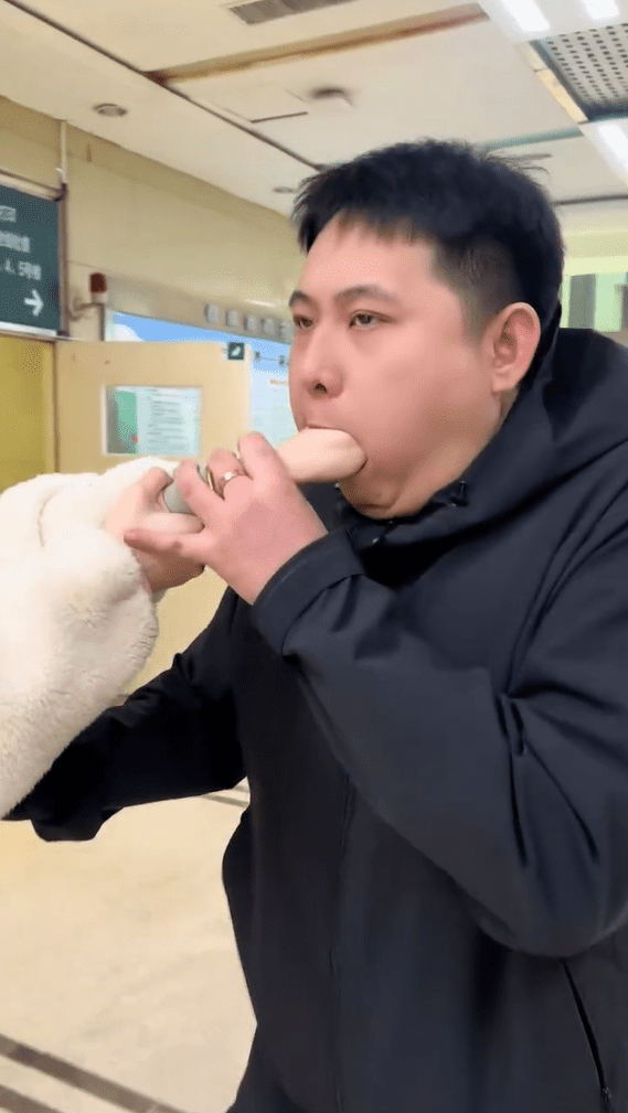 China man with GF's hand inside mouth