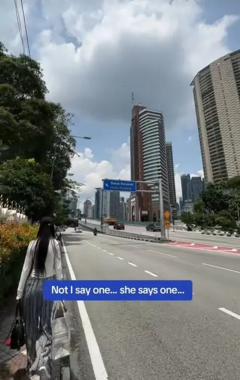 China tourist walking along the road in KL