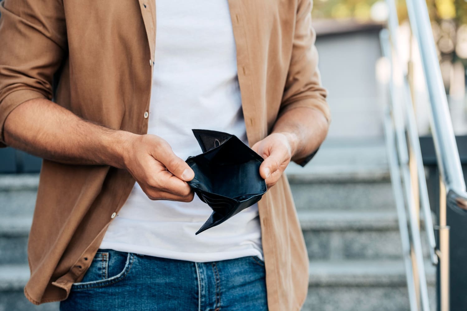 close-up-hands-holding-empty-wallet