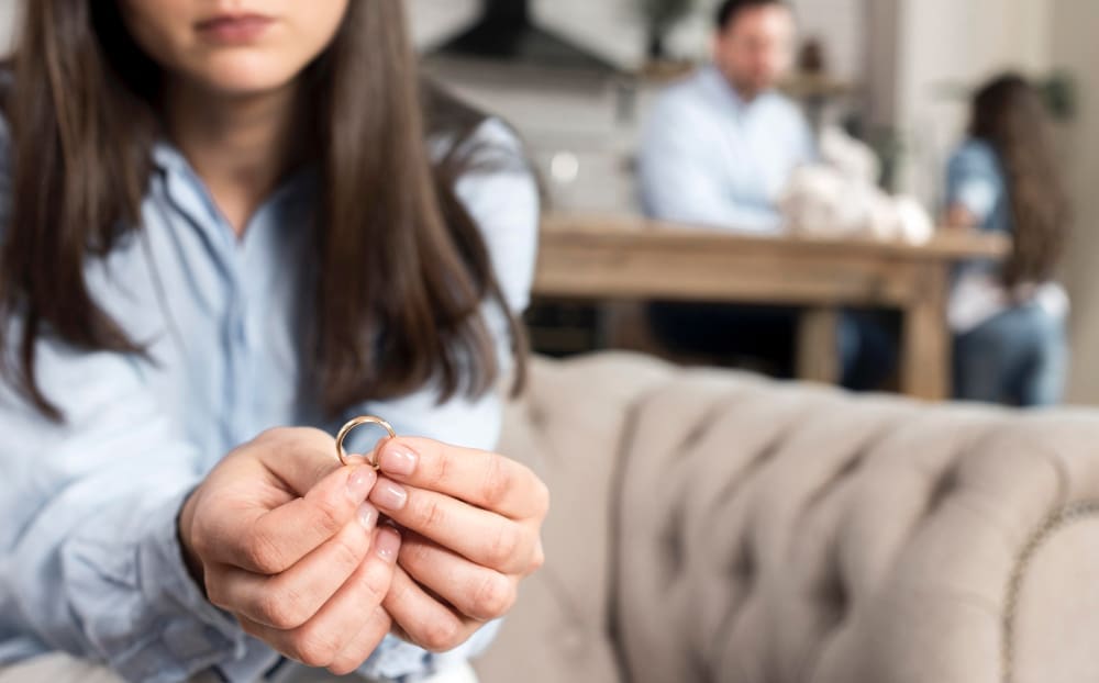 asian woman holding ring in stressed