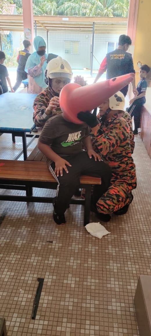 Johor firefighters free boy's head from traffic cone