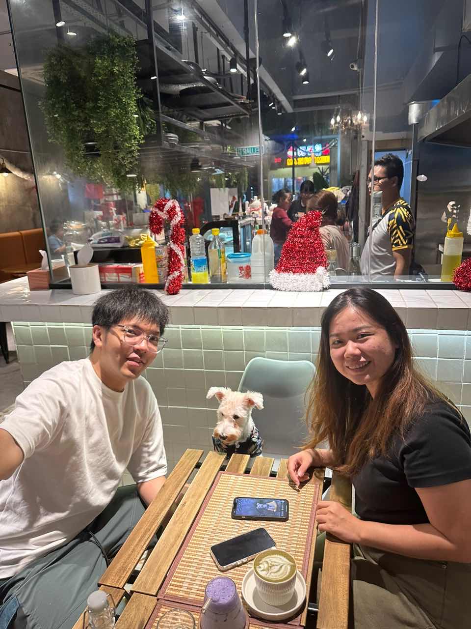 couples with their dog having coffee at a cafe