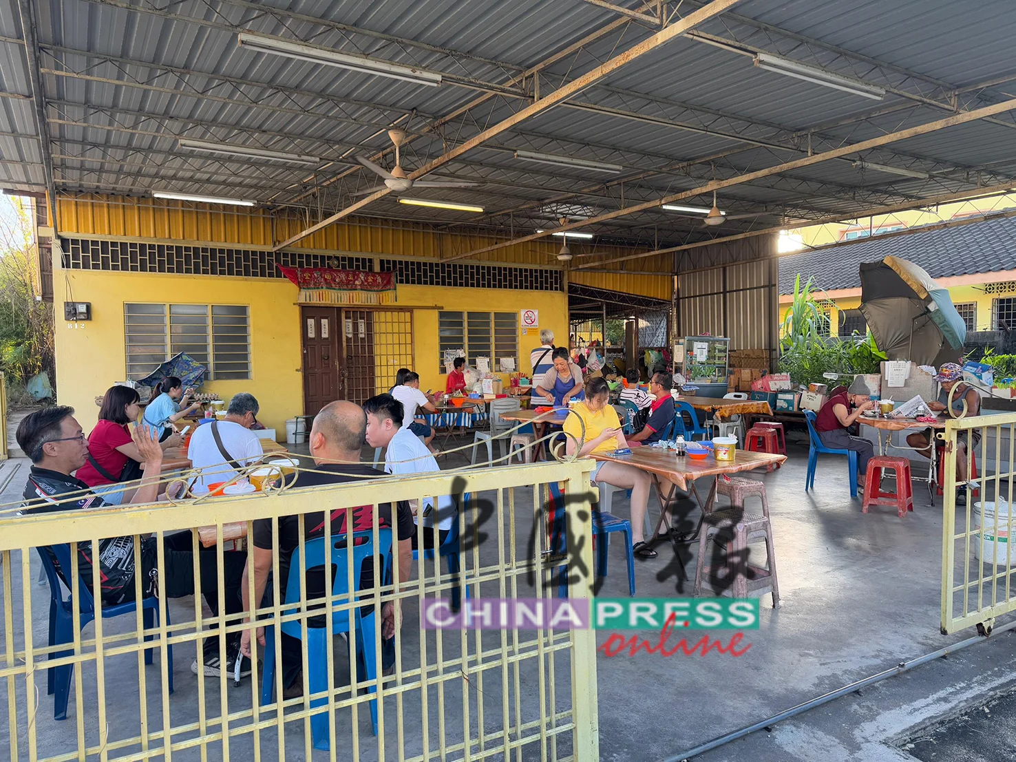Customers having breakfast at a noodle stall in Sungai Petani