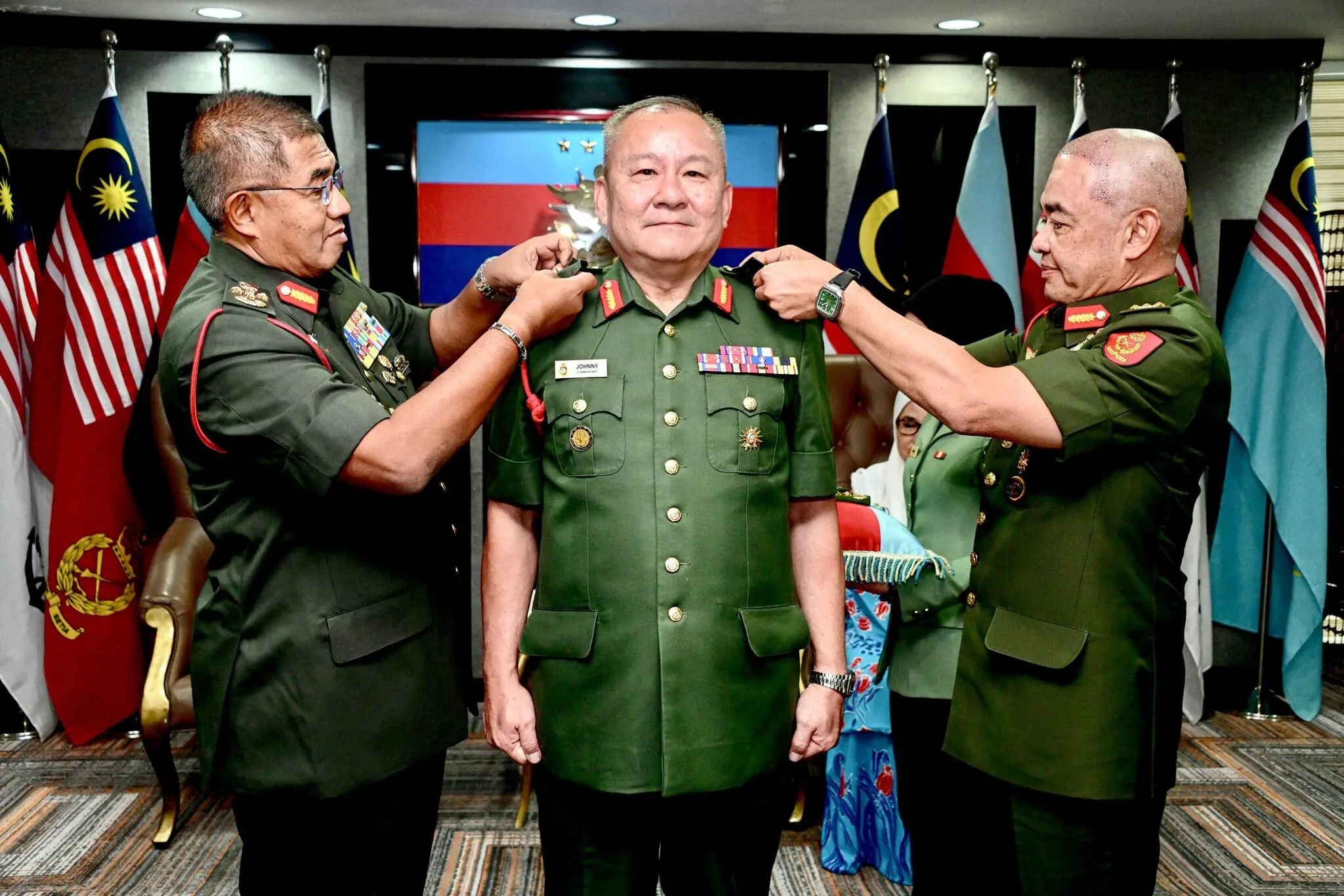 Datuk Johnny Lim receiving his promotion badges