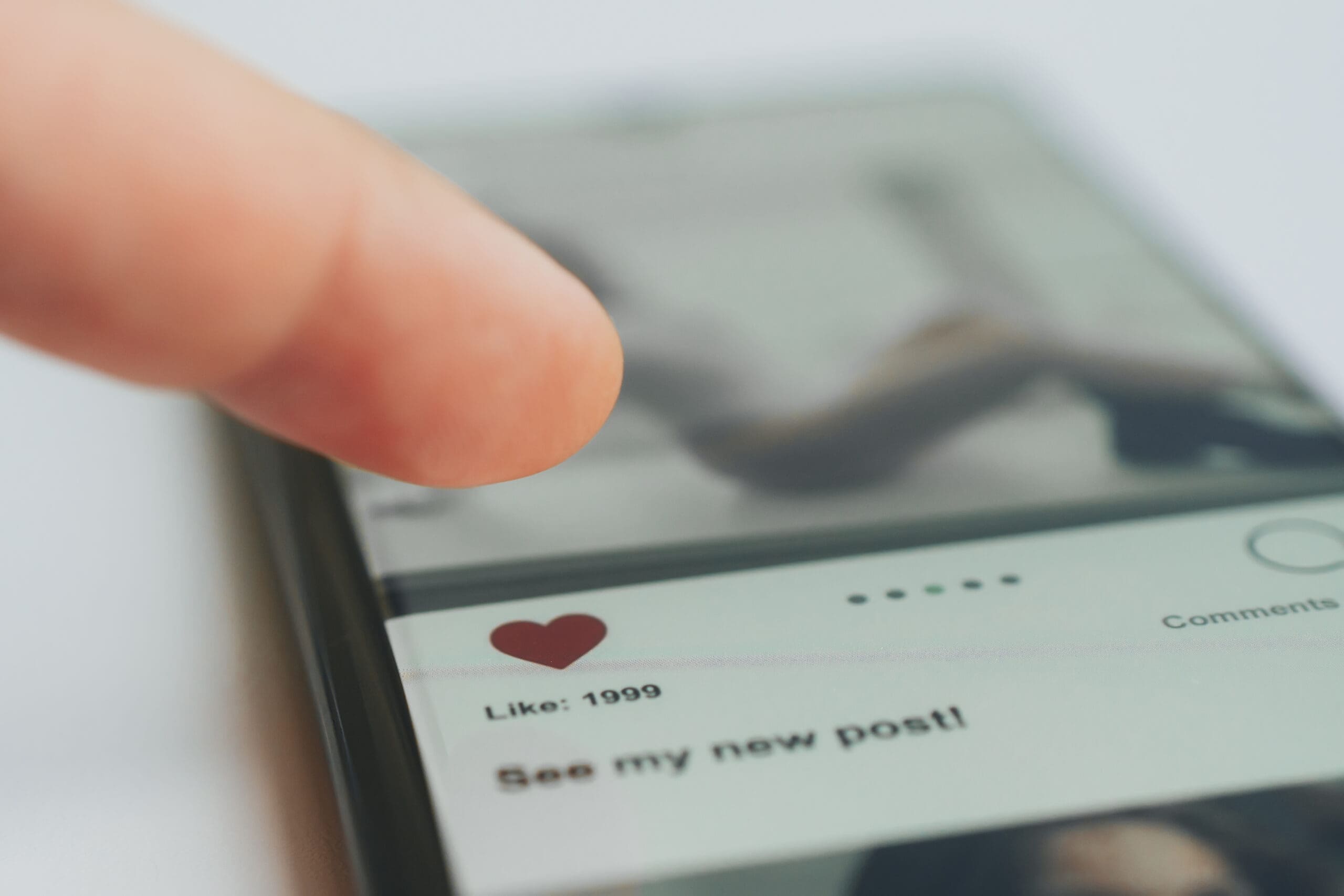 A person tapping like button on Instagram post