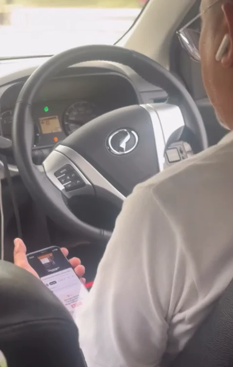E-hailing driver watches phone while driving (2)