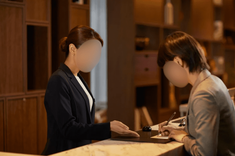 Female receptionist at hotel front desk