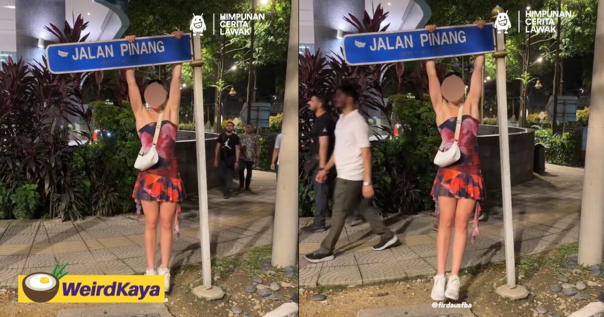 Female Tourist Hangs From Road Sign In M'sia Like It's A Monkey Bar & Bends It Sideways