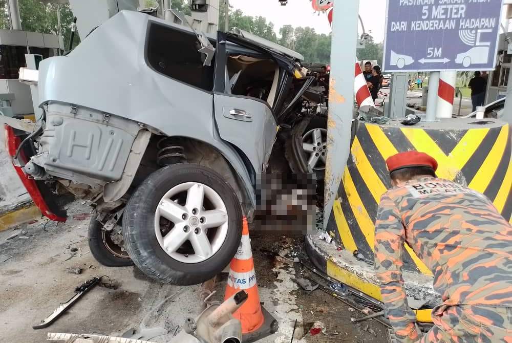 Firefighter inspecting Bukit Kajang Toll Plaza crash scene