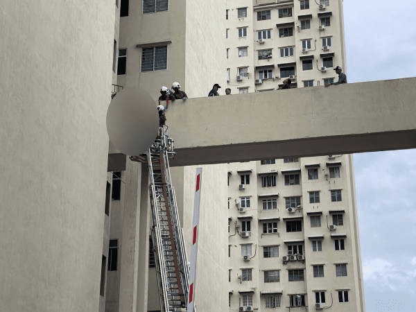 Firefighters removing body from Penang flat